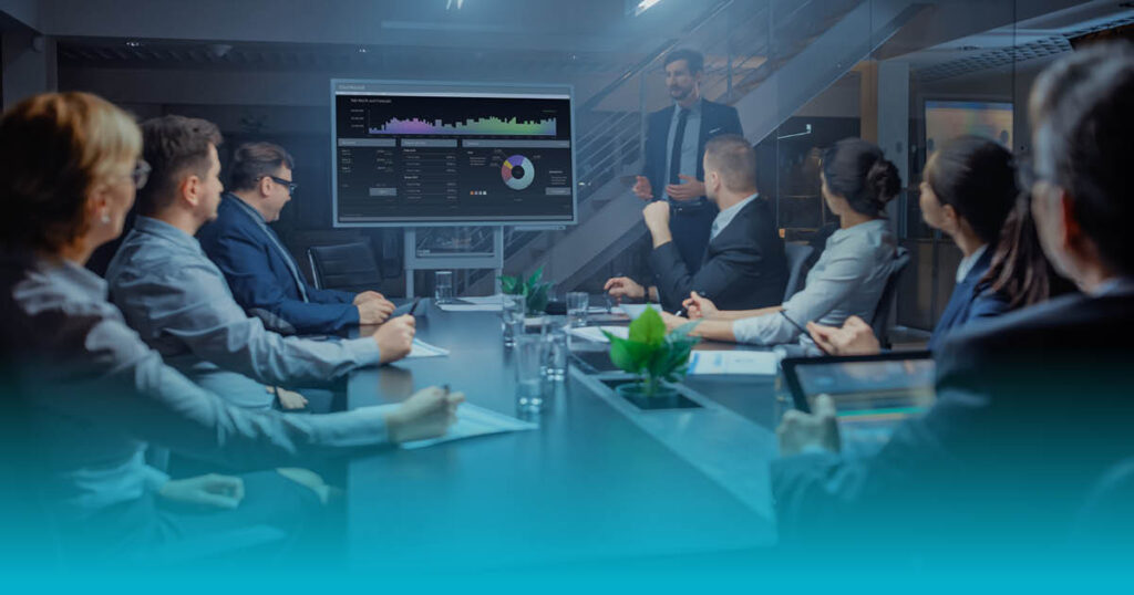 Business leaders reviewing workforce risk and compliance analytics during an executive boardroom meeting.